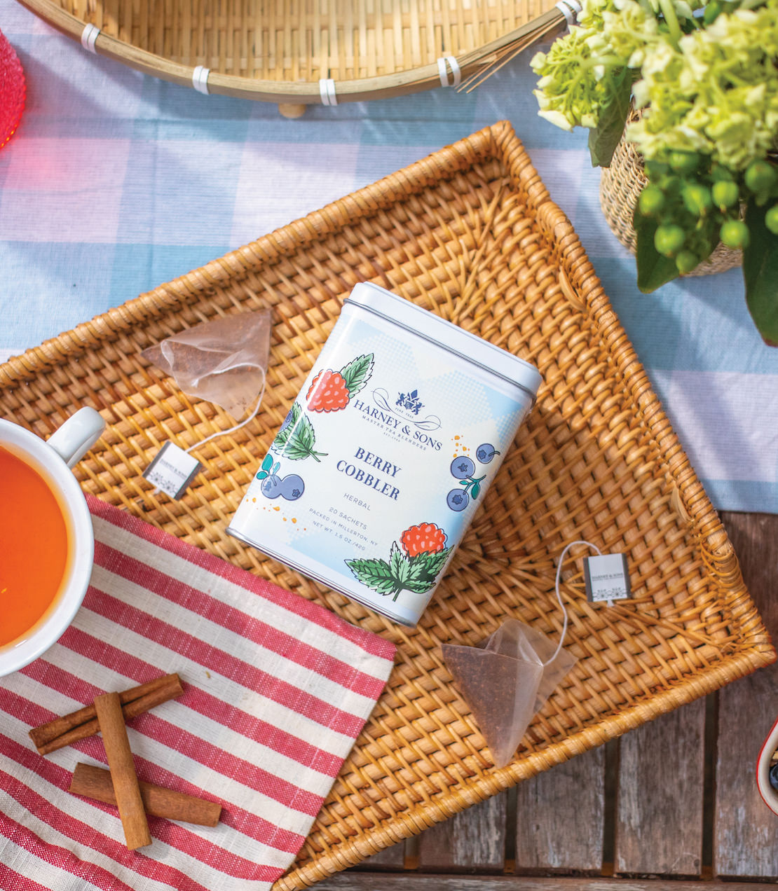 Harney & Sons Berry Cobbler, Tin of 20 Sachets, showcasing the product tin with sachets displayed in a cozy setting.