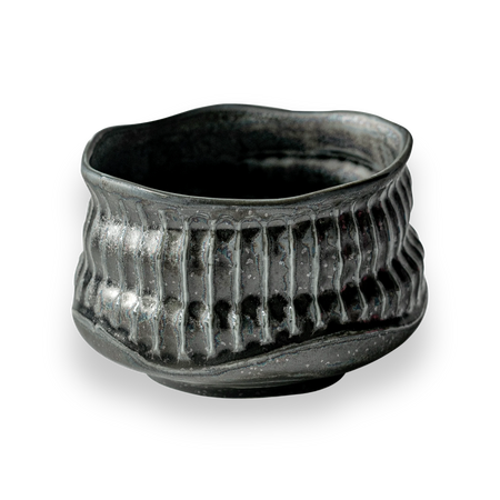 Aprika Life Black Ceramic Meisen Matcha Bowl featuring a ribbed texture, designed for matcha preparation, showcasing Japanese craftsmanship.