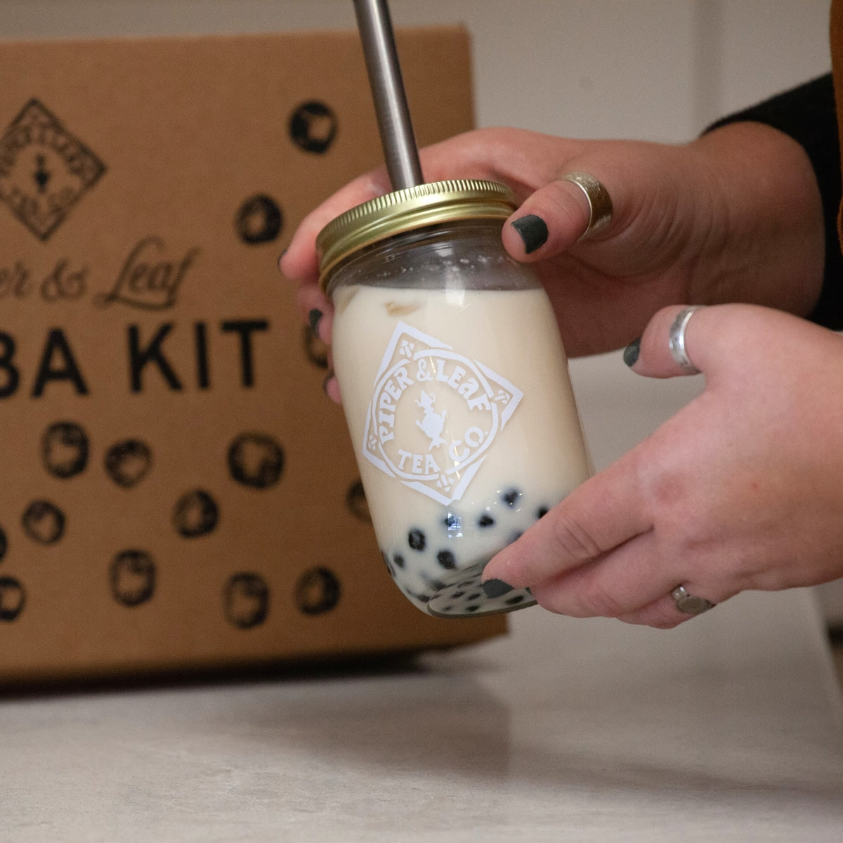 Boba Tea Kit by Piper and Leaf Tea Co., featuring ingredients and tools for making bubble tea in a pint container.