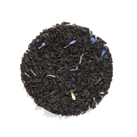 Plum Deluxe Breakfast in Bed Black Tea (Blackberry - Hazelnut) in a circular packaging with blue cornflowers displayed.