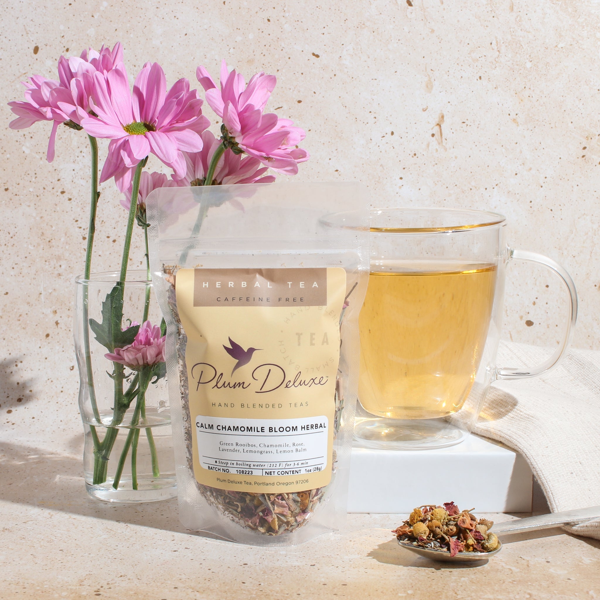Plum Deluxe Calm Chamomile Bloom Herbal Tea (Rose - Lavender) in a lifestyle setting, showcasing the tea packaging and ambiance.