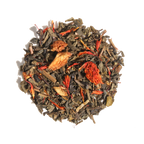 Plum Deluxe Candied Orange Green Tea in a circular tin, featuring a blend of green tea and candied orange notes.