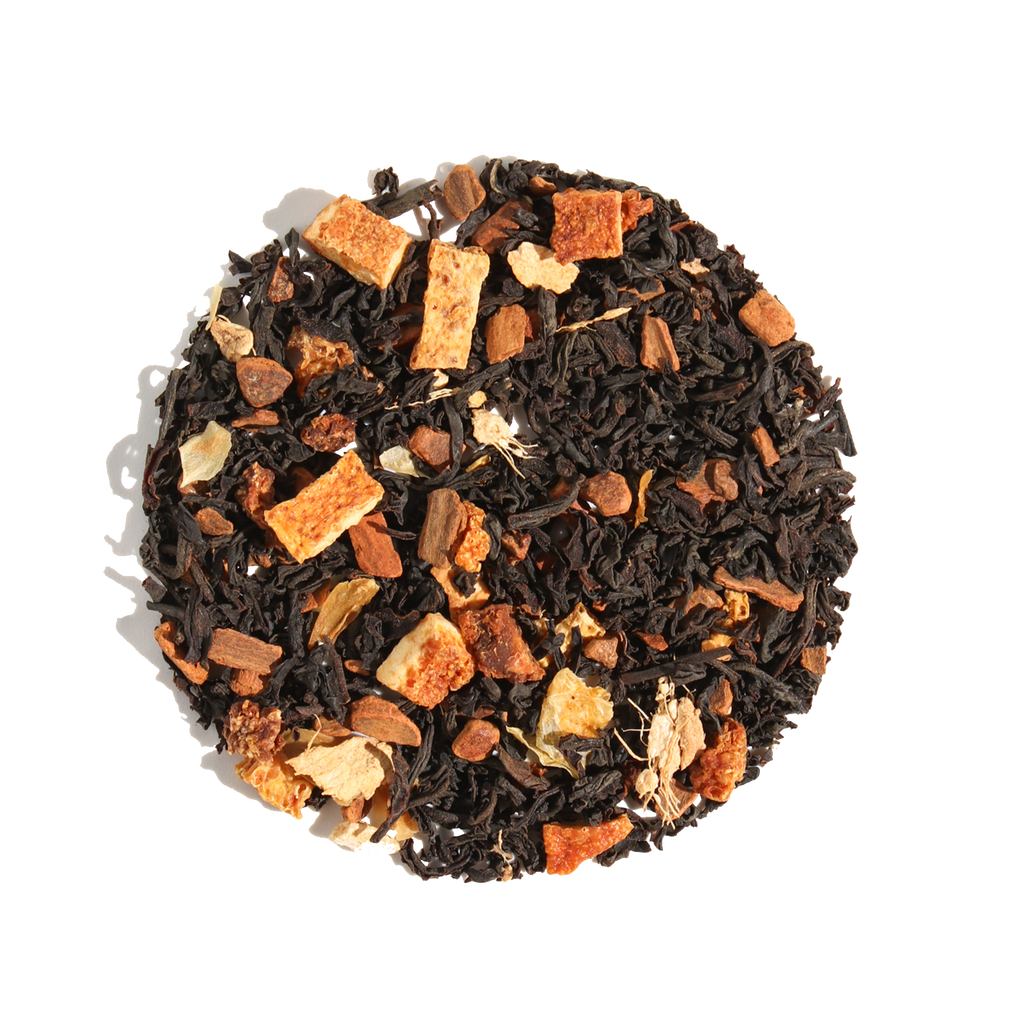 Plum Deluxe Comfort Blend Black Tea (Orange - Cinnamon) in a circular package, featuring orange and spice ingredients.