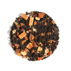 Plum Deluxe Comfort Blend Black Tea (Orange - Cinnamon) in a circular package, featuring orange and spice ingredients.