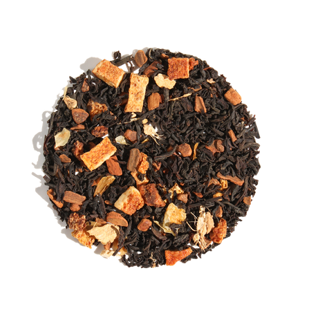 Plum Deluxe Comfort Blend Black Tea (Orange - Cinnamon) in a circular package, featuring orange and spice ingredients.