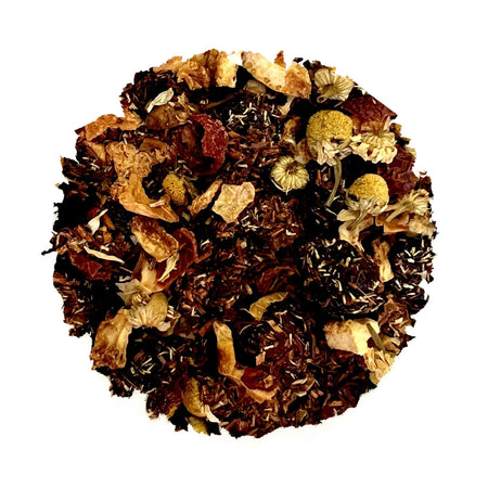 Beach House Cranberry Crush loose leaf tea blend featuring rooibos, cranberries, rose hips, and chamomile in a tea infuser.