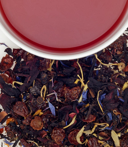 Harney & Sons Birthday Party - a cup of Decaf Birthday Tea showcasing a striking crimson color with fruity and floral notes.