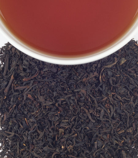 Harney & Sons Royal Palace tea in a cup, featuring black tea with lemon and grapefruit notes, in a traditional tin.