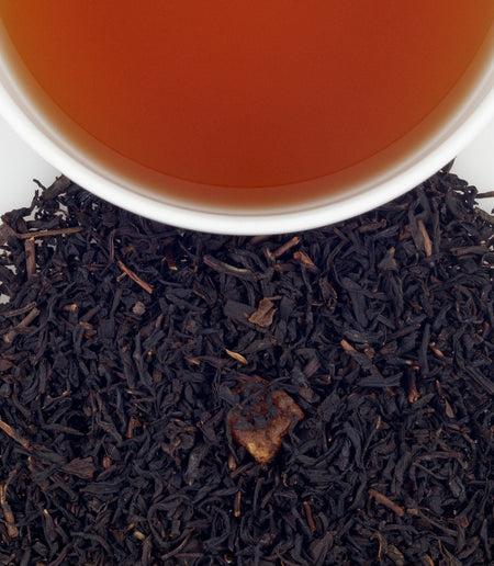 Harney & Sons Mango Black tea displayed in a cup, featuring vibrant mango pieces and medium-bodied black tea blend.