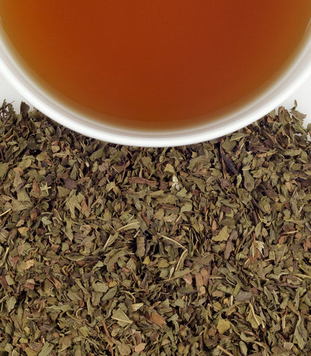 Harney & Sons Organic Peppermint herbal tea in a cup, showcasing its vibrant color and inviting aroma, sourced from Oregon.