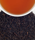 Cup of Harney & Sons Paris tea, a fruity black tea blend with vanilla, caramel, and bergamot notes, served in a tea cup.