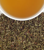 Harney & Sons Peppermint Herbal, HT Tin of 20 Sachets displayed in a cup, featuring peppermint herbal tea in a sachet.