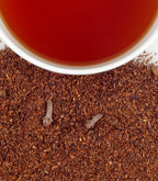 Harney & Sons Pumpkin Spice, HT Tin of 20 Sachets displayed in a cup, showcasing the tea's rich color and packaging.