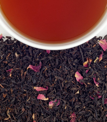A cup of Harney & Sons Sally's Secret tea featuring Earl Grey and pink rosebuds, symbolizing life and friendship.
