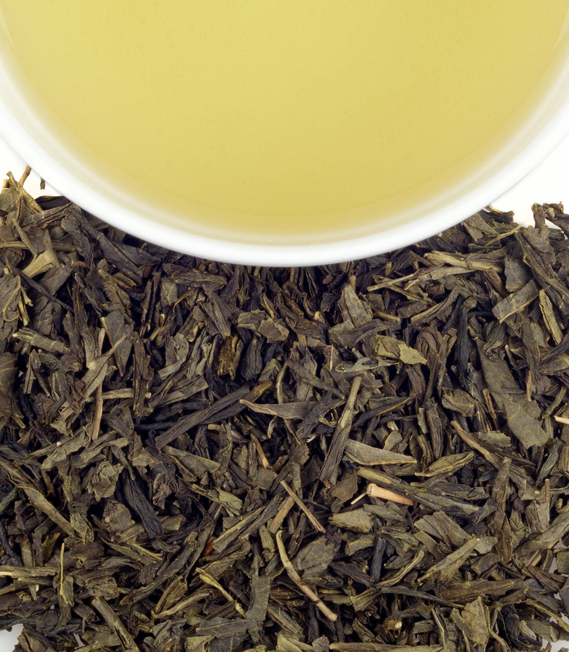 Harney & Sons Tropical Green, Tin of 20 Sachets, displayed in a cup, showcasing the tea's vibrant color and packaging.