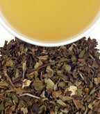 Harney & Sons White Christmas Tea, Tin of 20 Sachets, displayed in a cup with a festive background