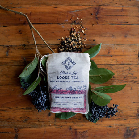 Piper and Leaf Elderberry Elixir Loose Leaf Tea - 15 Servings, herbal tea blend in hand-printed muslin bag on display.