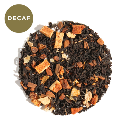 Plum Deluxe Comfort Blend Decaf Black Tea (Orange - Cinnamon) in a circular packaging, showing tea leaves and ingredients.