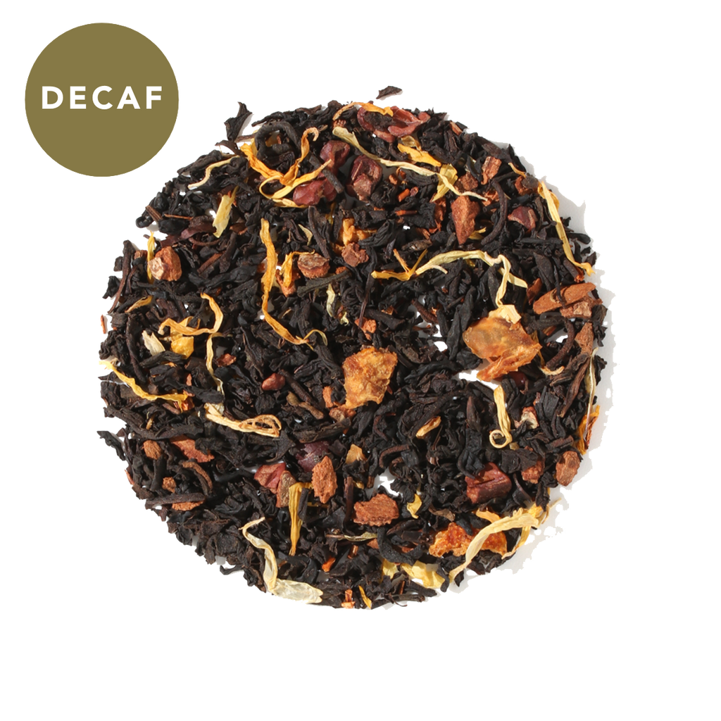 Plum Deluxe No Obligations Decaf Black Tea (Hazelnut - Almond - Cinnamon) in a circular package, showcasing its natural ingredients.