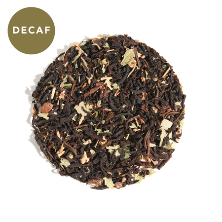 Plum Deluxe Wonder-Full Pomegranate Decaf Black Tea in a circular packaging, showcasing pomegranate arils and black tea blend.