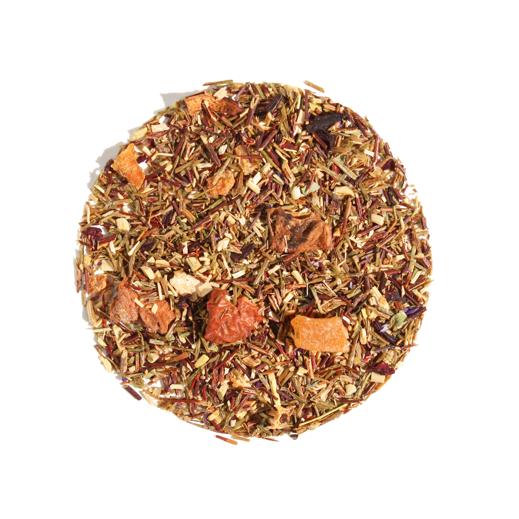 Plum Deluxe Dragonfruit Desire Herbal Tea in a circle graphic, featuring green rooibos, dragonfruit, mango, and hibiscus.