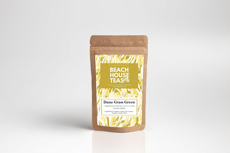 Beach House Dune Grass Green tea pouch featuring organic green tea leaves and lemon peel, presented in an inviting package.