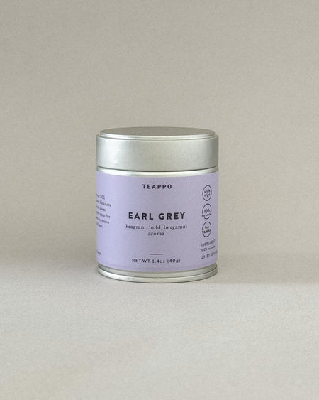 Teappo Earl Grey Powder in a tea tin, featuring a fragrant bergamot aroma and robust black tea for a refined tea experience.