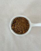 Teappo Earl Grey Powder in a clear jar with a label, displayed on a wooden surface