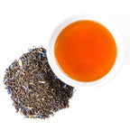 Piper and Leaf Front Porch Special Muslin Bag of Loose Leaf Tea - 15 Servings displayed with a couple enjoying tea.