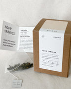 Teappo Four Springs herbal tea blend with natural ingredients in a clear package, displayed in the image.