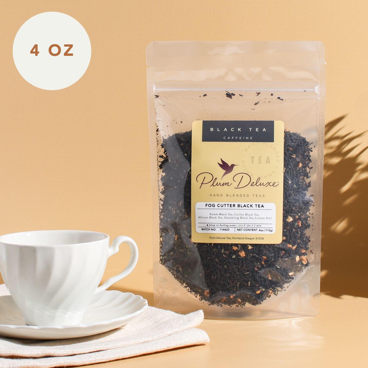 Plum Deluxe Fog Cutter Black Tea (Irish Breakfast w-Hint of Lemon) in a 4 oz package, featuring a vibrant tea blend.