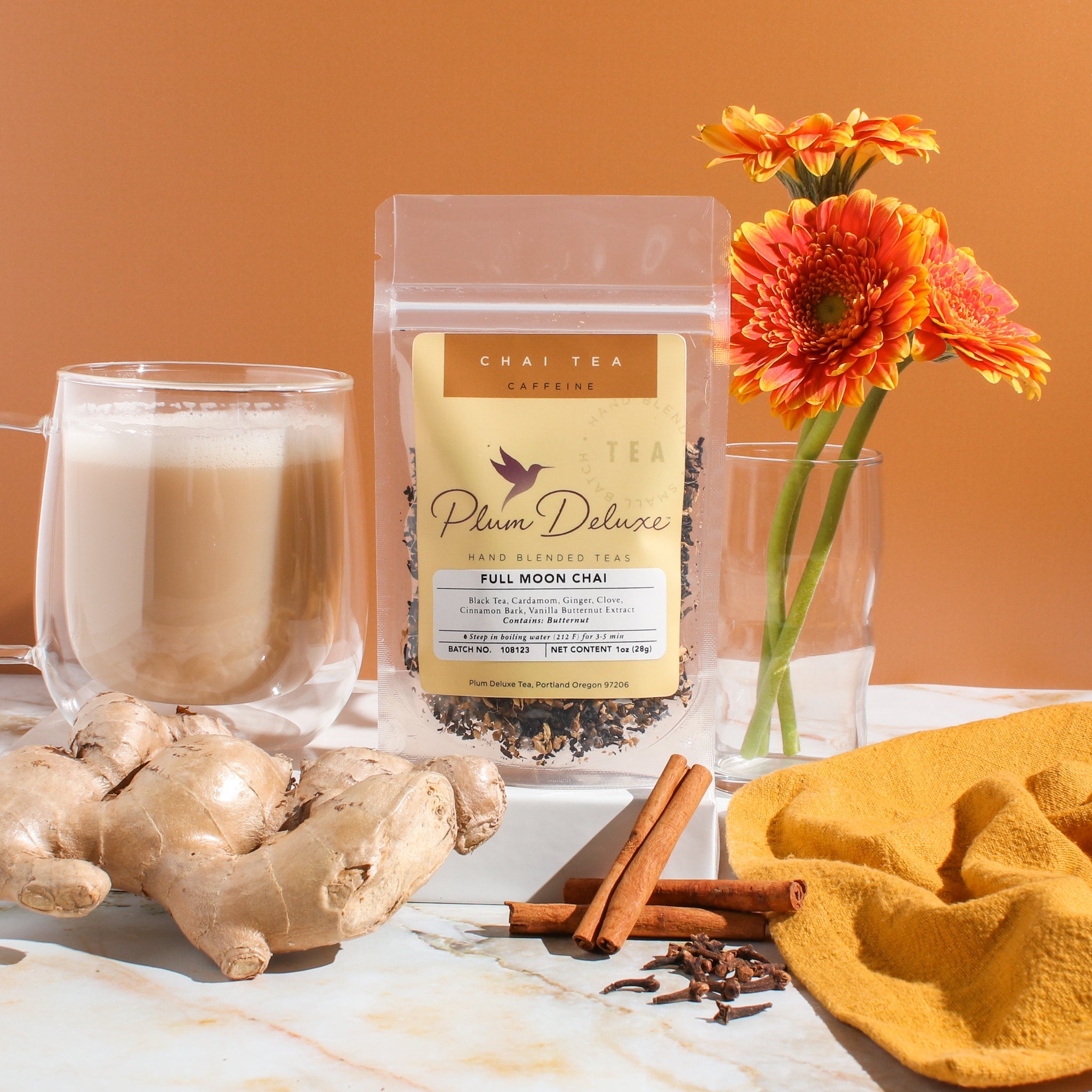 Plum Deluxe Full Moon Chai (Vanilla Butternut Masala Chai) in a lifestyle setting, showing packaging and a cup of tea.
