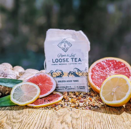 Piper and Leaf Golden Hour Tonic Muslin Bag of Loose Leaf Tea - 15 Servings, showing ingredients like ginger, turmeric, and fruits.