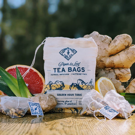 Piper and Leaf Golden Hour Tonic 9ct Tea Bags in Muslin, showing ingredients like ginger, turmeric, and grapefruit in muslin bags.