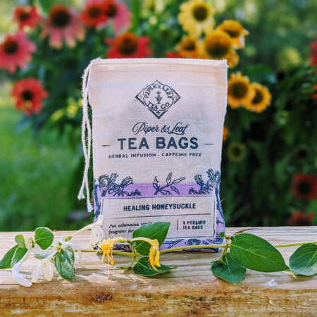Piper and Leaf Healing Honeysuckle 9ct Tea Bags in Muslin, featuring 9 pyramid sachets of herbal tea blend and hand-printed packaging.