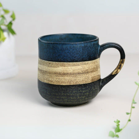 Aprika Life Handcrafted Mino Ware Ceramic Mug from Japan, 8 oz, features deep blue color with sand-toned stripe, unique design.