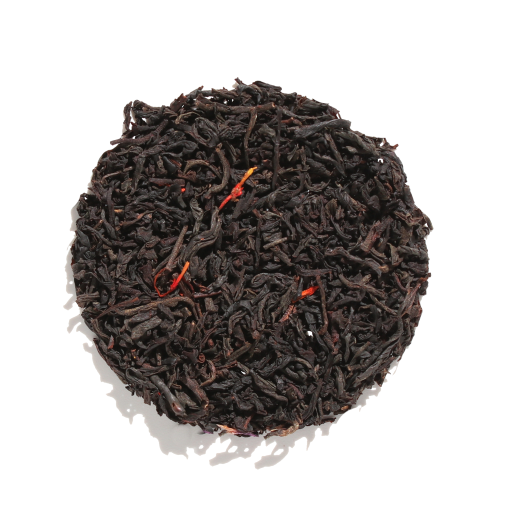 Plum Deluxe House Blend Black Tea (Creamy Vanilla English Breakfast) in a circular package, showcasing black tea blend details.
