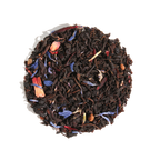 Plum Deluxe Huckleberry Happiness Black Tea, a blend of black tea and berries, shown in a circular package design.