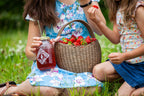 Piper and Leaf Strawberry Shindig Muslin Bag of Loose Leaf Tea - 15 Servings displayed in a clear container on a wooden surface.
