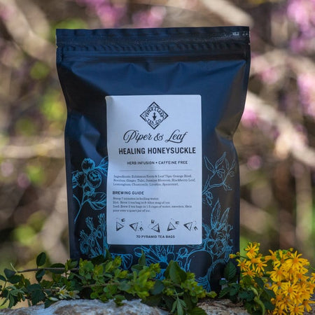 Piper and Leaf Healing Honeysuckle Bulk Sachets - 70ct Tea Bags, featuring a bag of assorted herbal tea sachets.