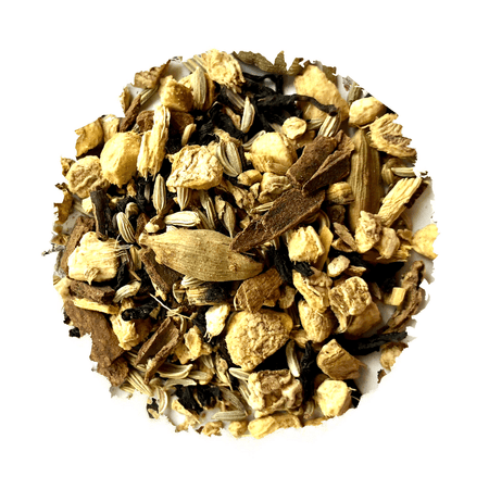 Beach House Inland Iced Chai blend in a clear glass, showcasing organic tea leaves and spices for summer refreshment.