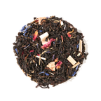 Plum Deluxe Kitchen Table Blend Black-Green Tea (with Secret Citrus Mix) in a circular packaging with citrus and floral imagery.