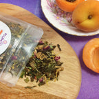 Plum Deluxe Lavender Daydream White Tea featuring mango, peach, and floral notes in a square packaging image.