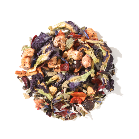 Plum Deluxe Magical Butterfly Herbal Tea with butterfly pea flowers and berries in a circular display.