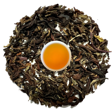 Danfe Himalayas Loose Leaf Spearmint Black Tea displayed with loose leaves and brewed tea liquor, showcasing its freshness and quality.