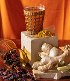 Harney & Sons Organic Ginger Turmeric tea package featuring vibrant ginger and turmeric imagery on a white background.
