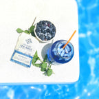 Piper and Leaf Piper Mint Blues 9ct Tea Bags in Muslin displayed in a lifestyle setting with brewed tea.