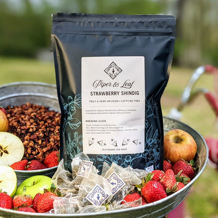 Piper and Leaf Strawberry Shindig Bulk Sachets - 70ct Tea Bags, featuring a bag of 70 tea sachets with apples, strawberries, and lemongrass.