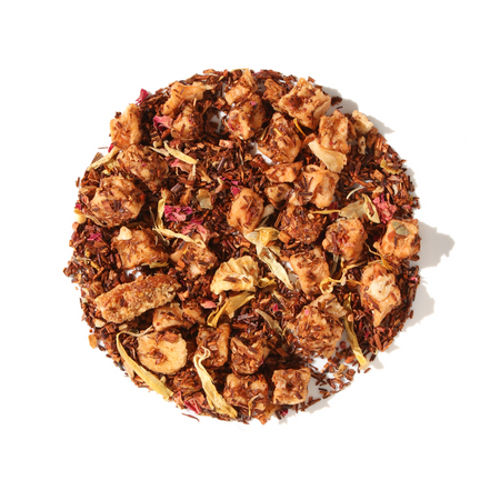 Plum Deluxe Peach Bellini Herbal Tea in a circular graphic, featuring vibrant fruit pieces like peach, mango, and strawberry.