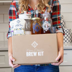 Piper and Leaf Piper Press Brew Kit displayed in a lifestyle setting, featuring brewing equipment and tea ingredients.
